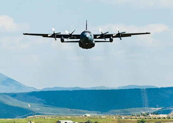 cargo aircraft in the sky above mountains