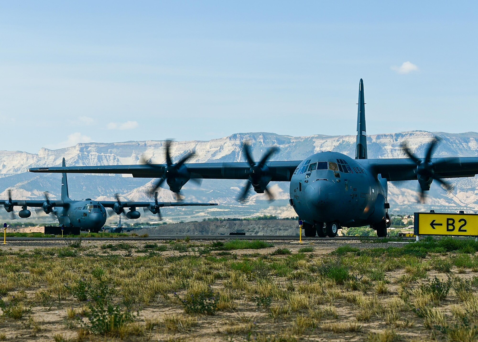 cargo aircraft in the sky above mountains