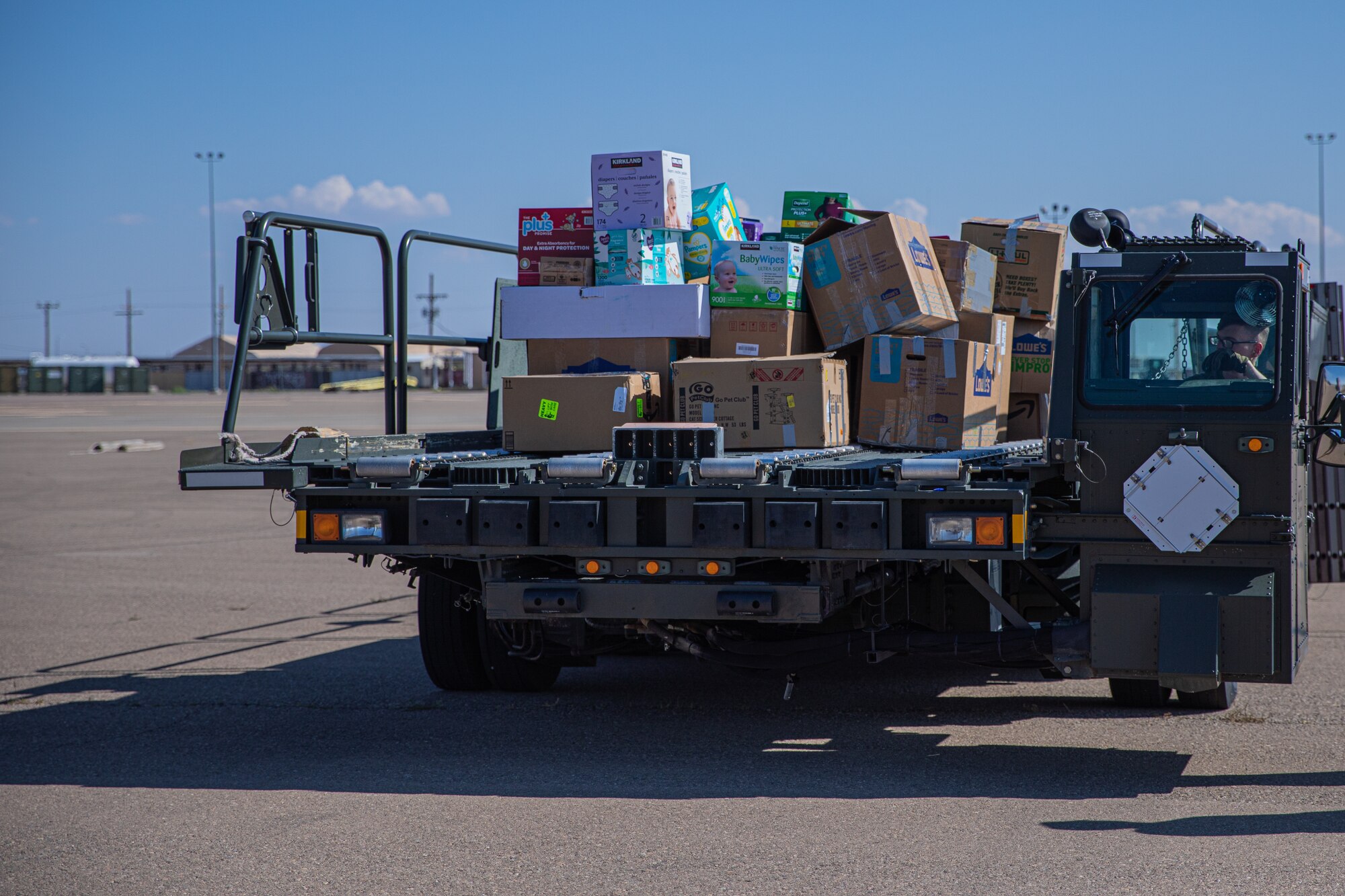 An Airman attached to Task Force-Holloman transports donations in support of Operation Allies Welcome on Holloman Air Force Base, New Mexico, Sept. 17, 2021. The Department of Defense, through U.S. Northern Command, and in support of the Department of State and Department of Homeland Security, is providing transportation, temporary housing, medical screening, and general support for at least 50,000 Afghan evacuees at suitable facilities, in permanent or temporary structures, as quickly as possible. This initiative provides Afghan evacuees essential support at secure locations outside Afghanistan. (U.S. Army photo by Pfc. Anthony Sanchez)
