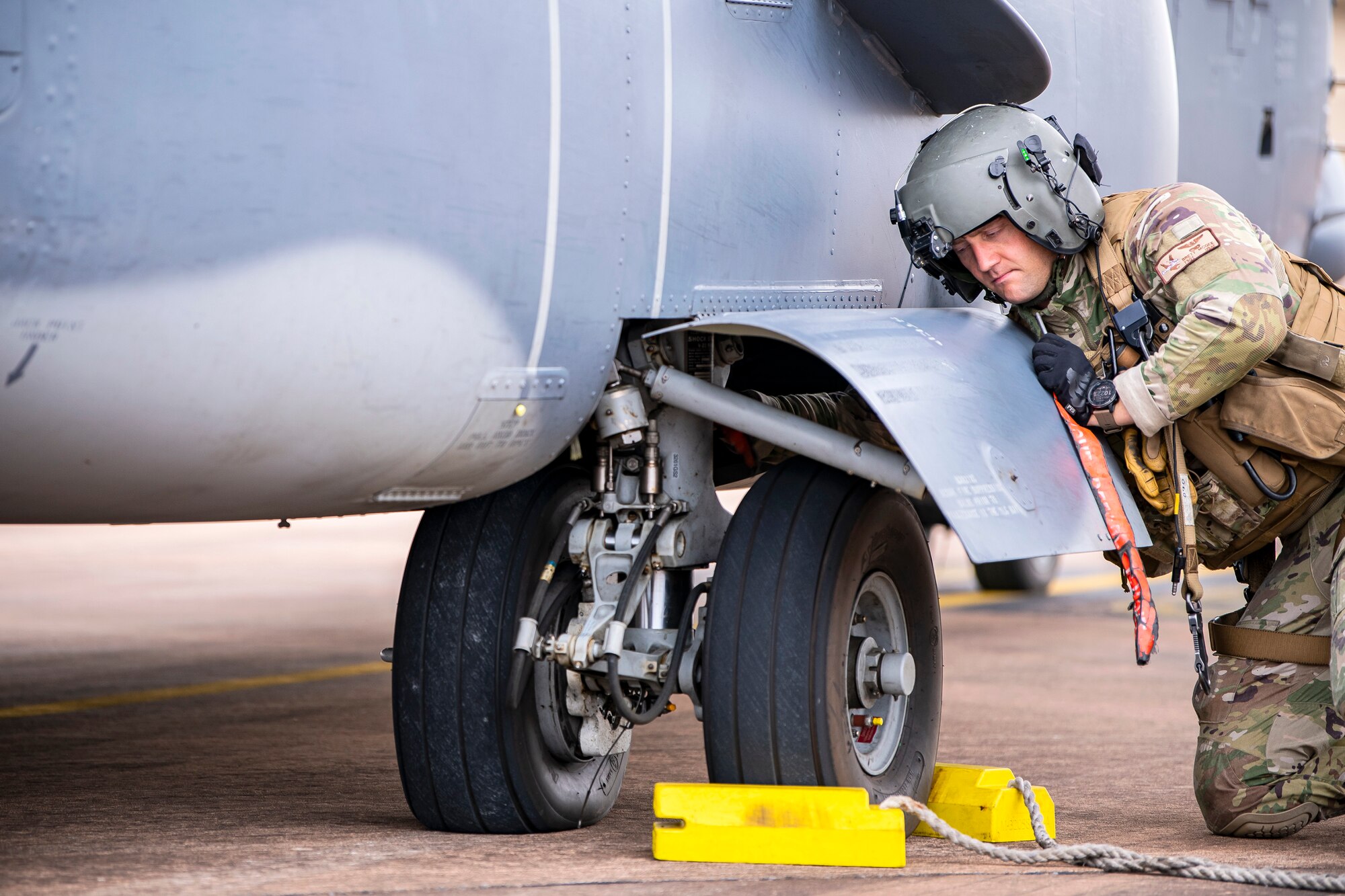 An aircrew member inspects the landing gear of a CV-22A Osprey during an Agile Combat Employment exercise at RAF Fairford, England, Sept. 13, 2021. Airmen from the 501st Combat Support Wing, 100th Air Refueling Wing and 352d Special Operations Wing partnered to conduct an ACE exercise to test their overall readiness and lethality capabilities. The exercise enables U.S. forces in Europe to operate from locations with varying levels of capacity and support. (U.S. Air Force photo by Senior Airman Eugene Oliver)