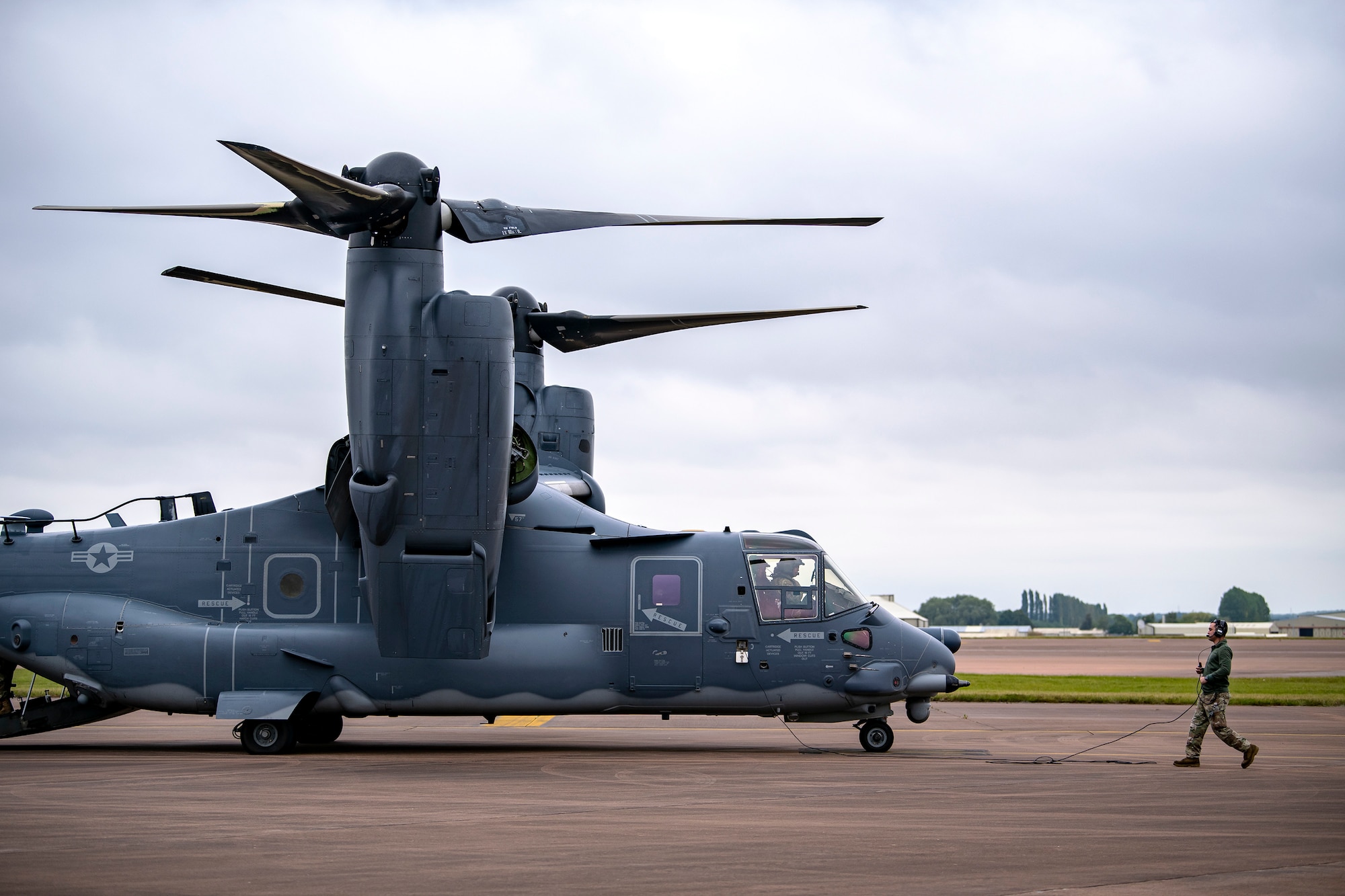 An Airman from the 352d Special Operations Wing prepares to marshall a CV-22A Osprey during an Agile Combat Employment exercise at RAF Fairford, England, Sept. 13, 2021. The exercise enables U.S. forces in Europe to operate from locations with varying levels of capacity and support. This further ensures Airmen and aircrews are postured to deliver lethal combat power across the full spectrum of military operations.(U.S. Air Force photo by Senior Airman Eugene Oliver)