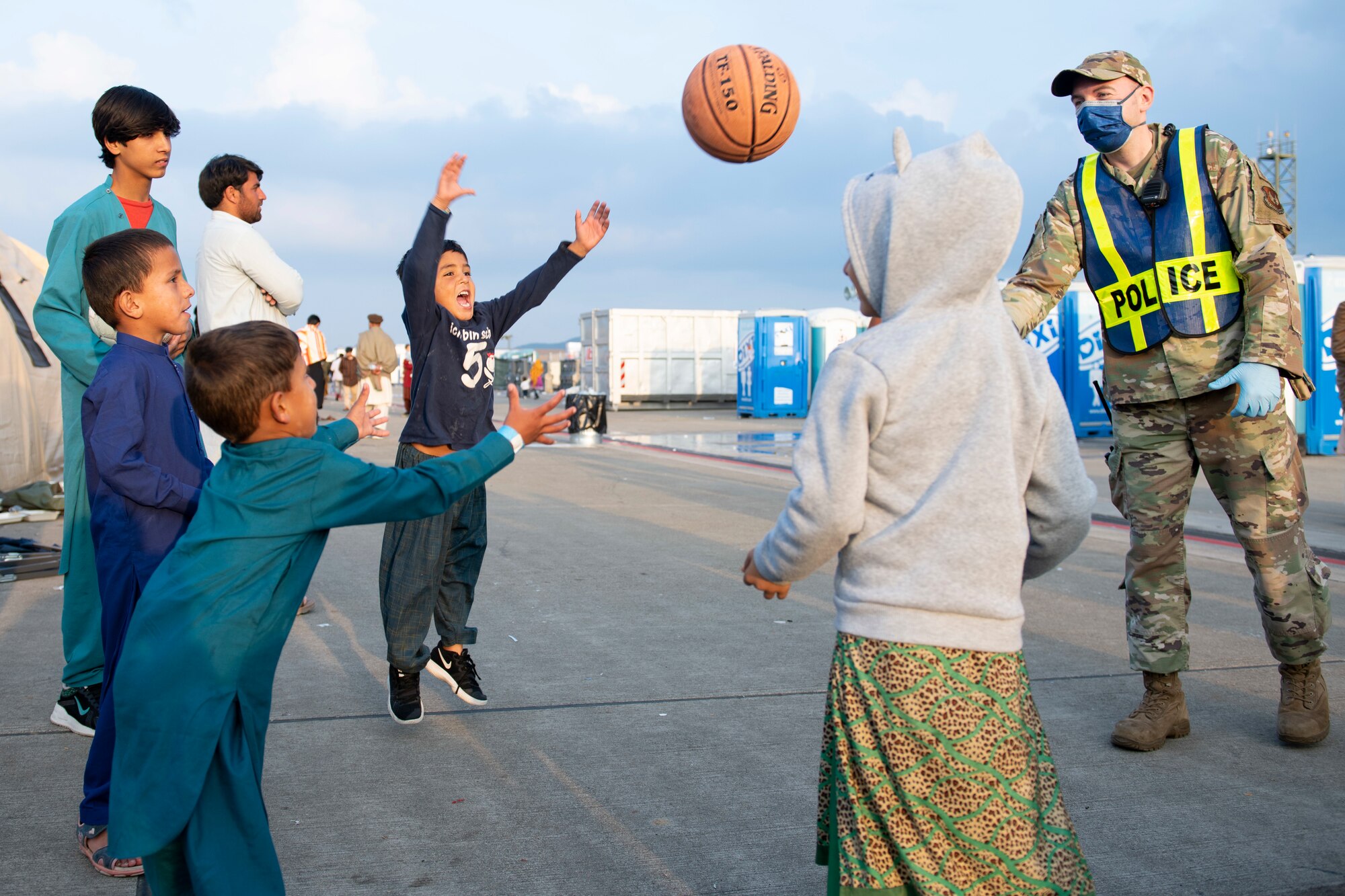 U.S. Air Force Tech. Sgt. Johnny Conley, 423rd Security Forces flight sergeant and POD 2 lead assigned to Royal Air Force Alconbury, England, plays a game with children during Operation Allies Refuge at Ramstein Air Base, Germany, Aug. 31, 2021. Volunteers work around the clock to support evacuees during their time at Ramstein while they wait for transportation to the United States and other safe locations. Ramstein Air Base transformed into U.S. European Command’s primary evacuation hub, supporting one of the largest, most complex humanitarian airlift operations in history. (U.S. Air Force photo by Senior Airman Jennifer Zima)