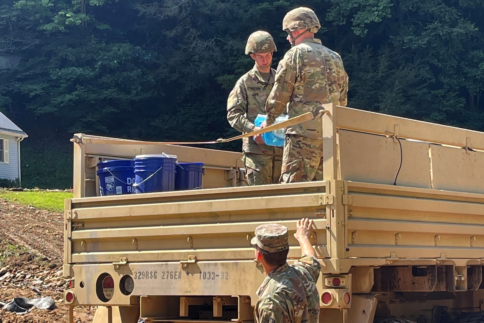 Virginia National Guard Soldiers assigned to the Cedar Bluff-based 1033rd Engineer Company deliver water to residents impacted by flooding Sept. 3, 2021, in Buchanan County, Virginia.