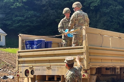 Virginia National Guard Soldiers assigned to the Cedar Bluff-based 1033rd Engineer Company deliver water to residents impacted by flooding Sept. 3, 2021, in Buchanan County, Virginia.