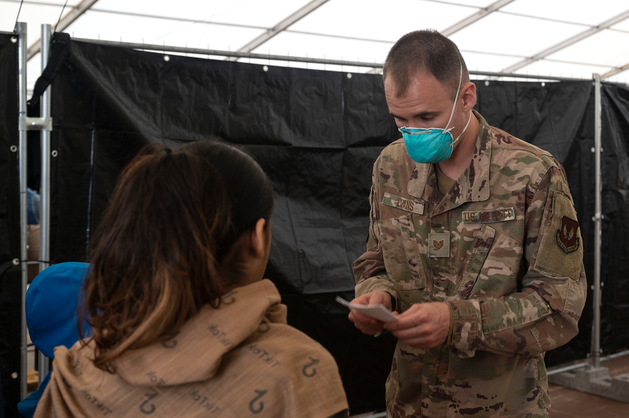 Airman assists evacuees.