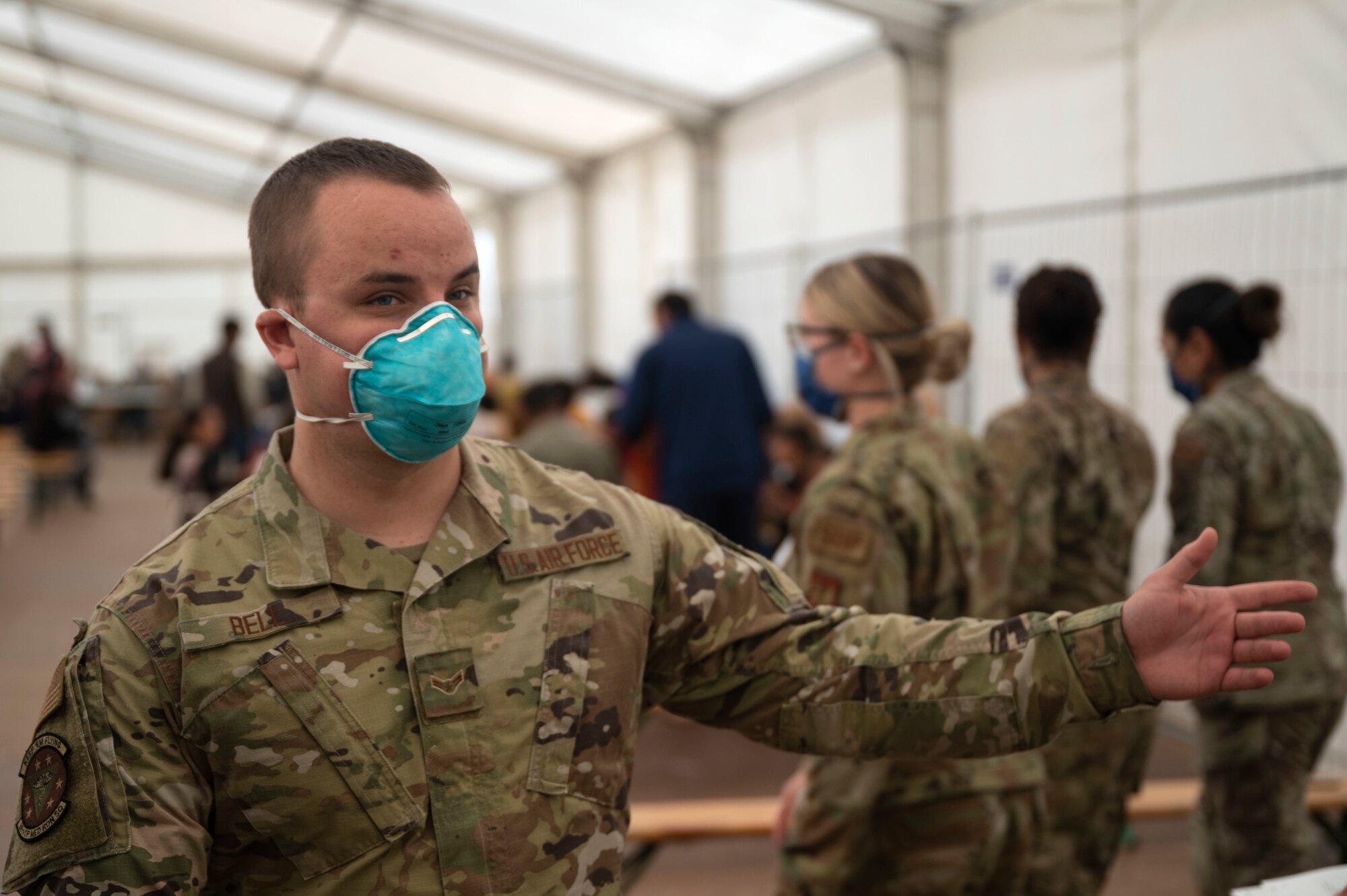 Airman direct evacuees to different stations.