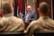 Incoming Product Manager Air Warrior (PdM), Dr. Carlos Correia, addresses Col. Derek Bird, Project Manager, Soldier Survivability (right), after assuming the role during a Change of Charter ceremony on Redstone Arsenal, Alabama, July 16. PdM AW is a product management office within the Program Executive Office  Soldier portfolio.