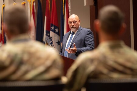 Incoming Product Manager Air Warrior (PdM), Dr. Carlos Correia, addresses Col. Derek Bird, Project Manager, Soldier Survivability (right), after assuming the role during a Change of Charter ceremony on Redstone Arsenal, Alabama, July 16. PdM AW is a product management office within the Program Executive Office  Soldier portfolio.
