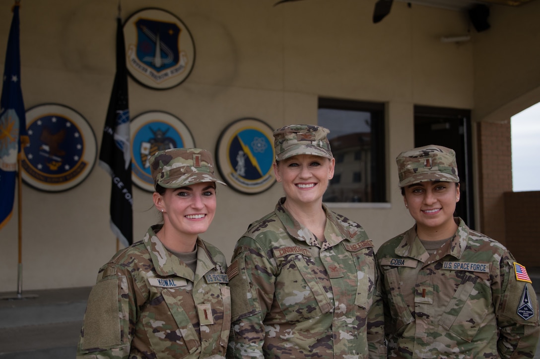 Two Space Force lieutenants pose with Air Force colonel.