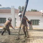 The joint, combined engineer team methodically lay concrete masonry blocks for the walls of the new concrete medical building at the Tabarka regional Hospital in Tabarka, Tunisia, Aug. 18, 2021.