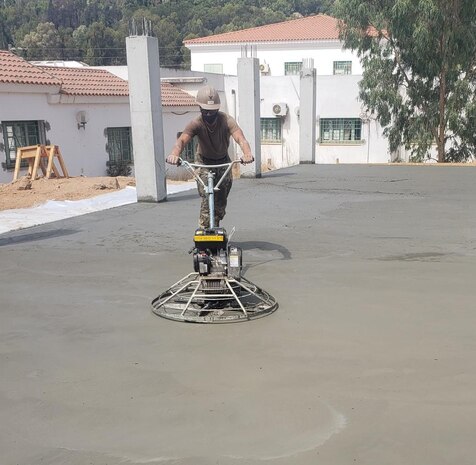 Builder Constructionman 3rd Class Rylee McGuire from Naval Mobile Construction Battalion 11, finishes the concrete floor slab in Tabarka, Tunisia, Aug. 18, 2021.