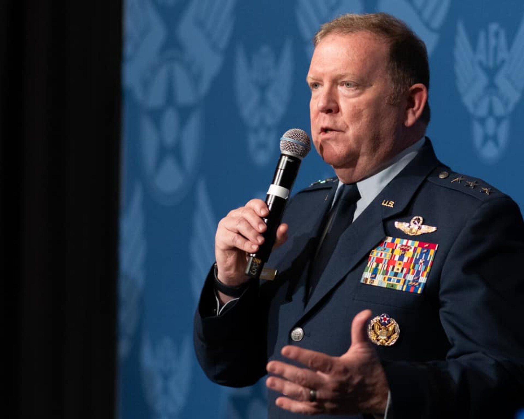 Air Force Reserve commander Lt. Gen Richard Scobee speaks into a microphone.