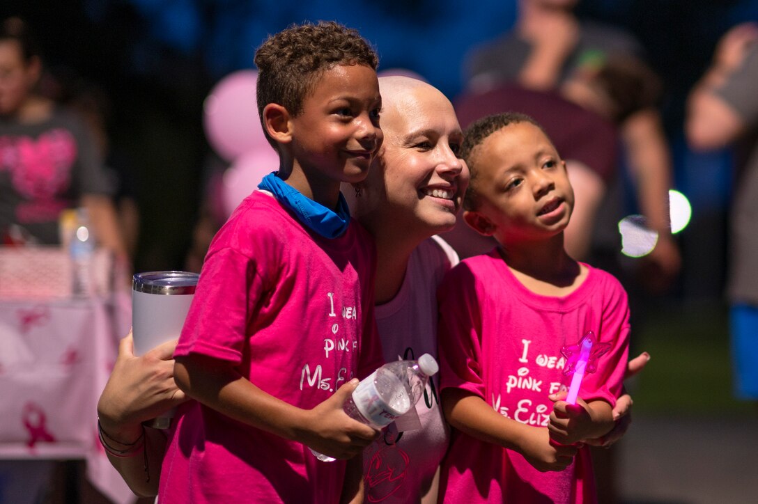 Photo of three people standing side by side