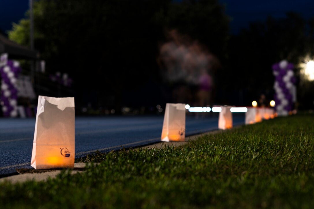 Photo of person running at night past luminaries
