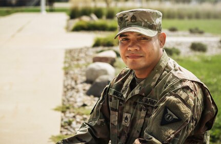 Staff Sgt. Henry Meza, an Iowa Army National Guard Soldier who works with the Service to Citizenship program, poses for a photo at the Camp Dodge Joint Maneuver Training Center in Johnston, Iowa, on Sept. 7, 2021. Meza grew up with a large family in Honduras, and became a U.S. citizen in 2013.