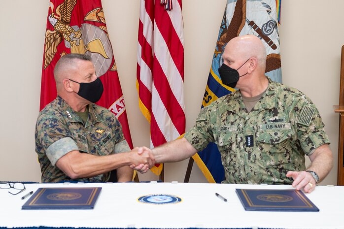 U.S. Marine Corps Lt. Gen. Robert F. Hedelund, commander, Fleet Marine Corps Atlantic, and Adm. Christopher W. Grady, commander, U.S. Fleet Forces Command, shake hands following the signing of the Naval Integration Campaign Plan (NICP) Sept. 20 in the Rotunda at U.S. Fleet Forces Command. The NICP is a progressive step in operationalizing the Commandant’s Planning Guidance, A Design for Maintaining Superiority, and Advantage at Sea. The plan will ensure “One Fight, One Navy” force global posture. U.S. Navy Photo by Chief Mass Communication Specialist Mary Popejoy/RELEASED