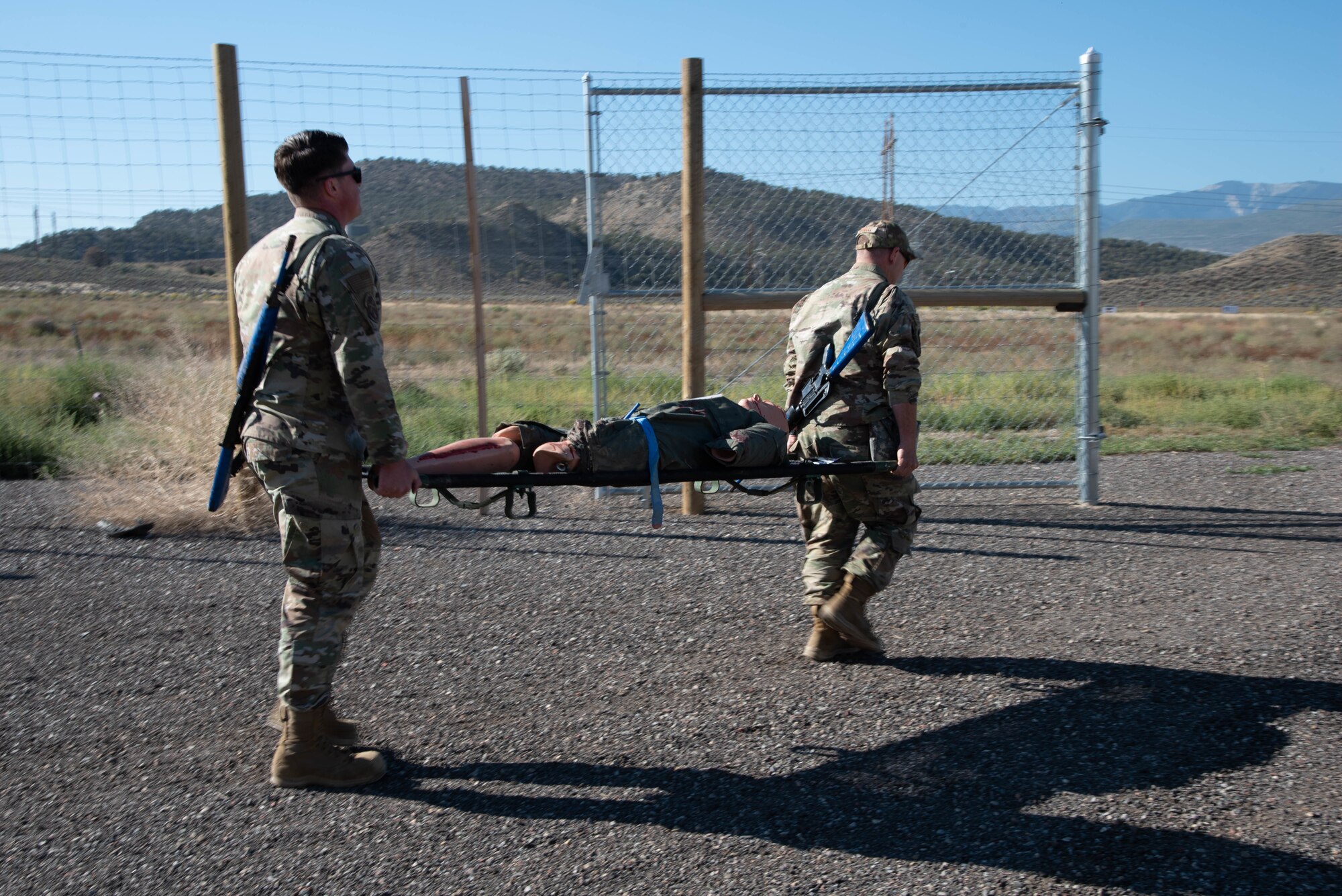 Two Airmen carrying a stretcher with a medical dummy