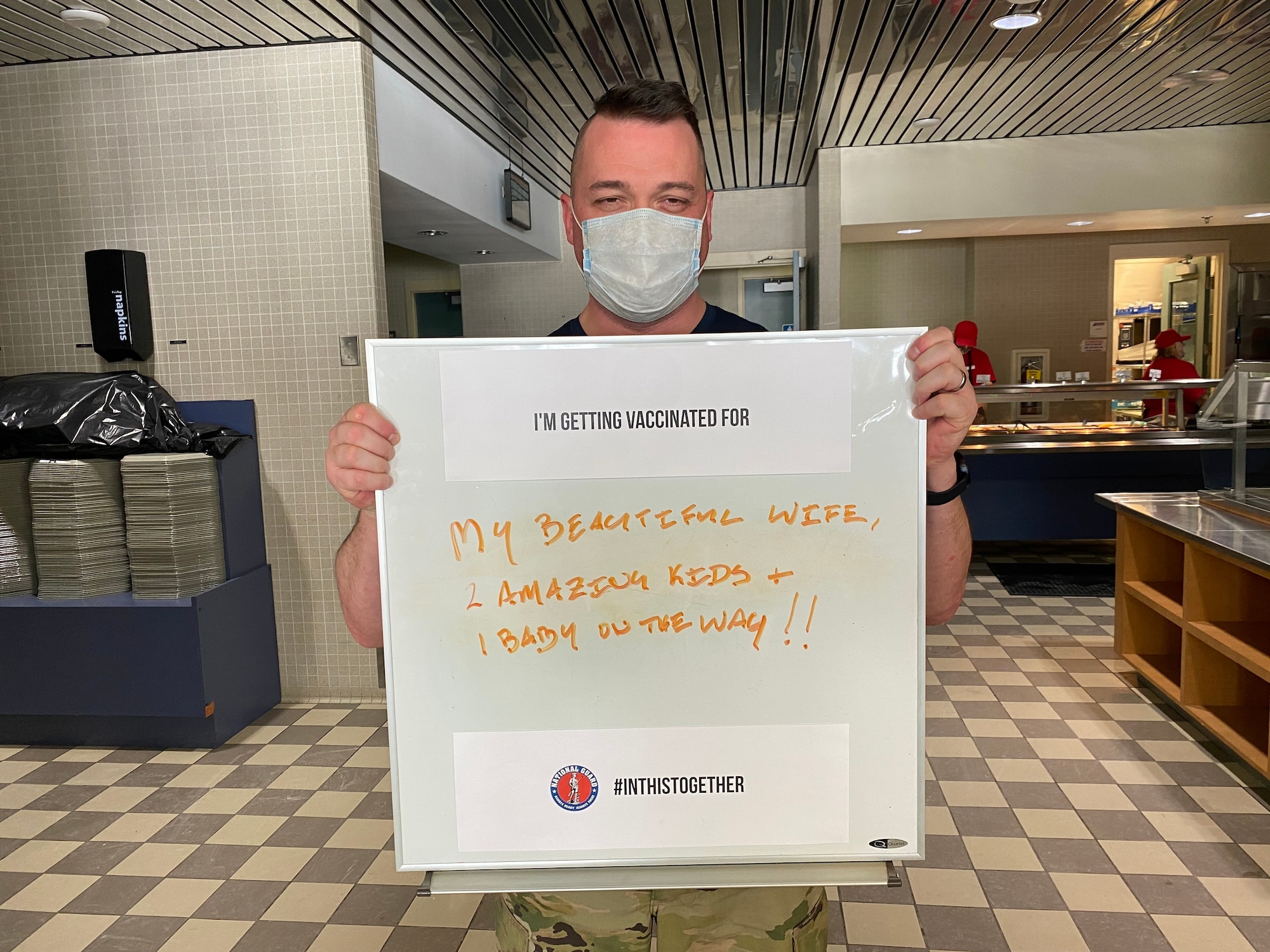 A member of the 128th Air Refueling Wing holds up a sign signifying why they are choosing to receive the COVID-19 Vaccine here at 128th Air Refueling Wing, Milwaukee, Feb. 7, 2020. The 128th Air Refueling Wing has begun the distribution of the COVID-19 vaccine in coordination with the U.S. Department of Defense's Operation Warp Speed. (U.S. Air National Guard photo by Master Sgt. Kellen Kroening)