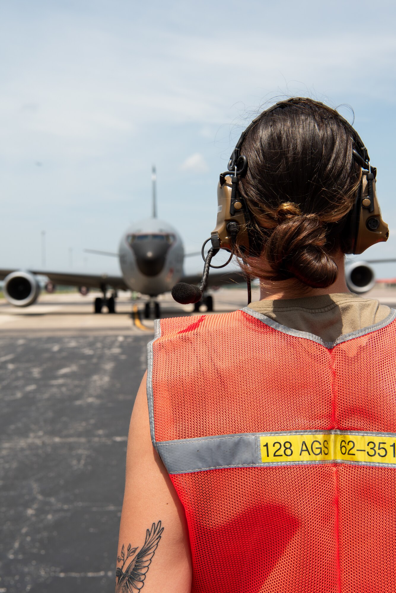 Staff Sgt. Renatta Purdy, a crew chief with the 128th Air Refueling Wing, Wisconsin Air National Guard, pauses for a 128th Air Refueling Wing KC-135R Stratotanker as it prepares for takeoff during exercise Arctic thaw at MacDill Air Force Base, Florida, April 23, 2021. Arctic Thaw is an off station independent-operations exercise that provides new fighter pilots an opportunity to practice refueling and refueling wings an opportunity to complete annual training.