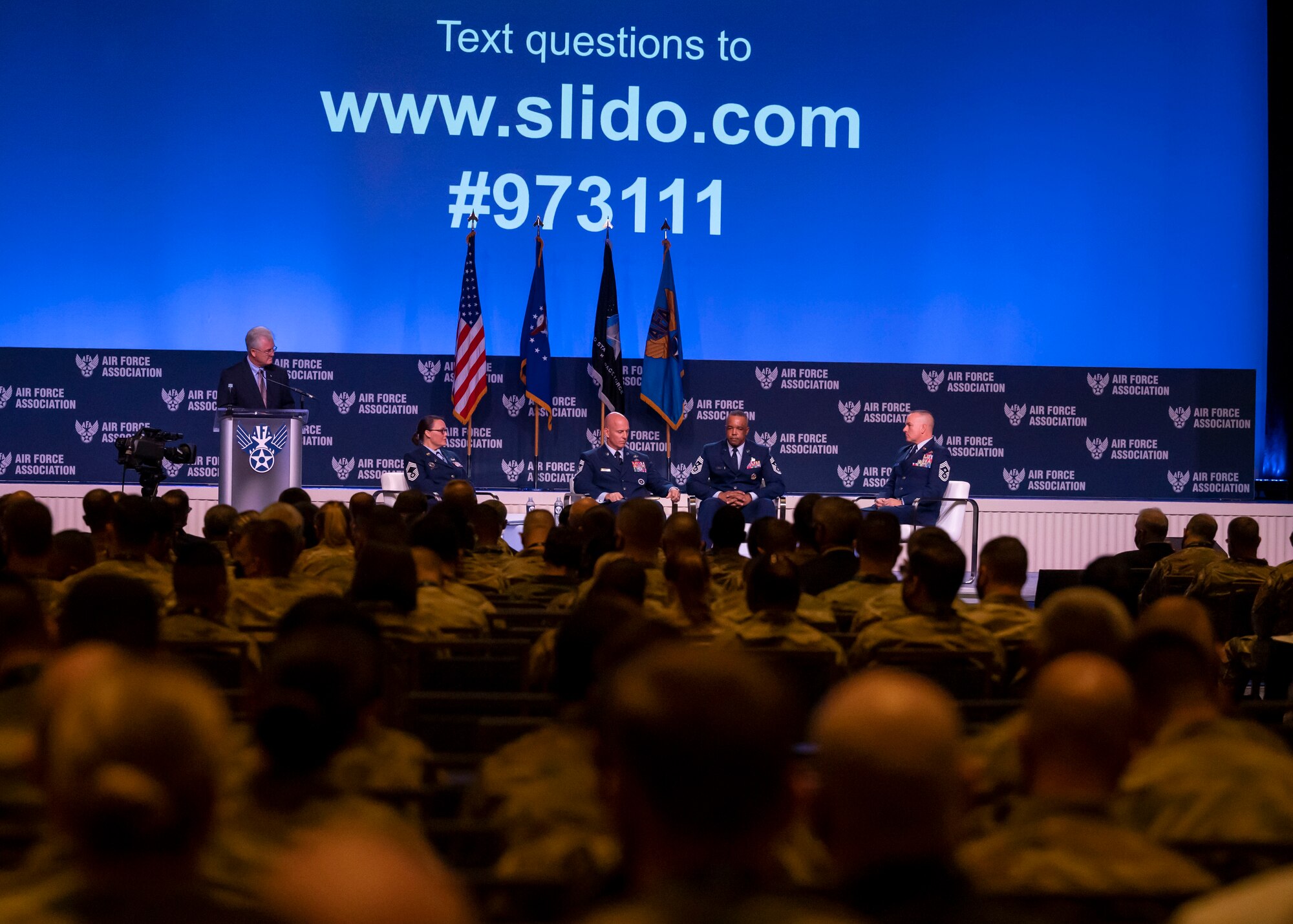 Photo of Airmen attending a leadership panel during a conference