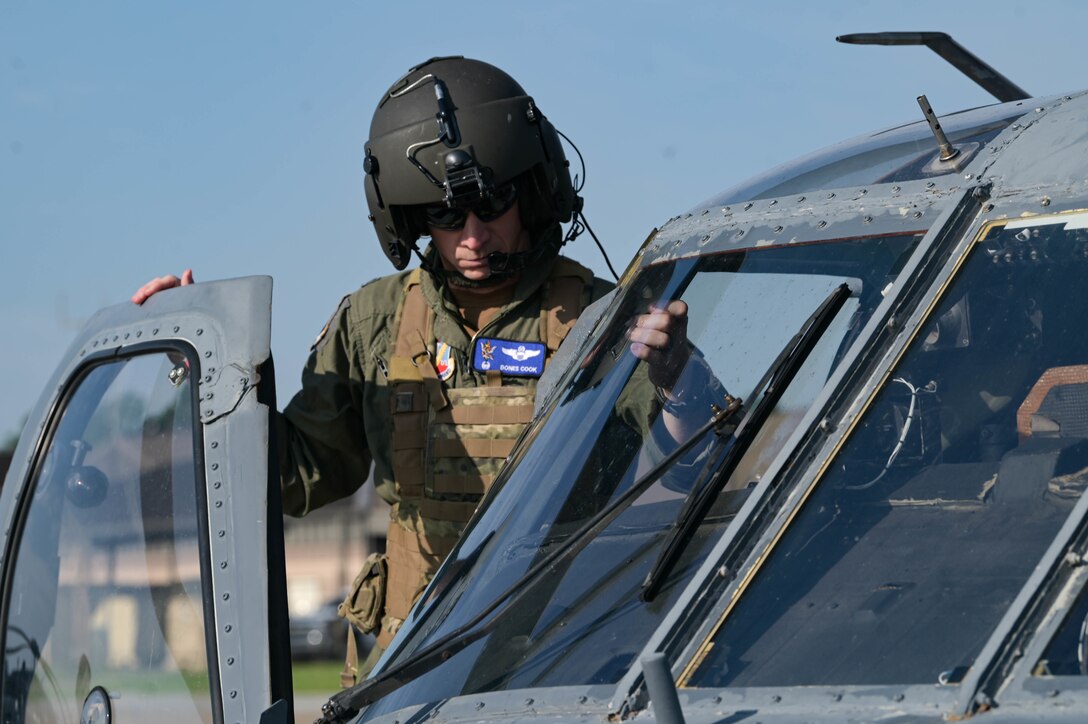 man getting inside a helicopter