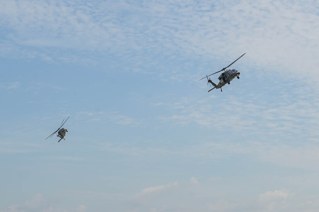 2 helicopters in the air