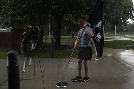 An Airman places the POW/MIA flag in front of a memorial during a retreat ceremony at Joint Base Charleston, South Carolina, Sept. 16, 2021. The Defense POW/MIA Accounting Agency’s mission is to provide the fullest possible accounting for missing personnel to their families and the nation. Currently 83,000 service members unaccounted for. (U.S. Air Force photo by Airman 1st Class Jade Dubiel)