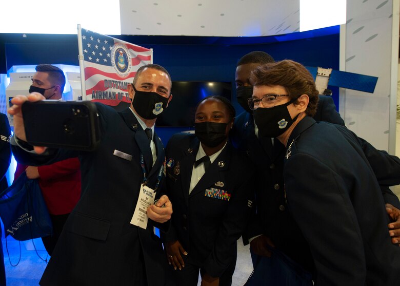 Senior Airman Jamonica Smith, 87th Security Forces Squadron Phoenix Raven Team member, Joint Base McGuire-Dix-Lakehurst, poses for a photo with Gen. Jacqueline D. Van Ovost, commander of Air Mobility Command, and Chief Master Sergeant Brian P. Kruzelnick, command chief of Air Mobility Command, during the Air Force Association Air, Space and Cyber Conference at National Harbor, Md., Sept. 20, 2021. Smith was recognized as one of the 2021 12 Outstanding Airmen of the Year based on superior leadership, job performance and personal achievement. (U.S. Air Force photo by Staff Sgt. Nicolas Z. Erwin)