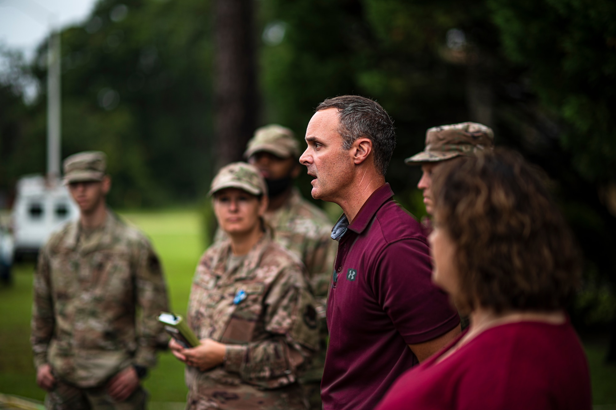 Photo of person talking to a group of people