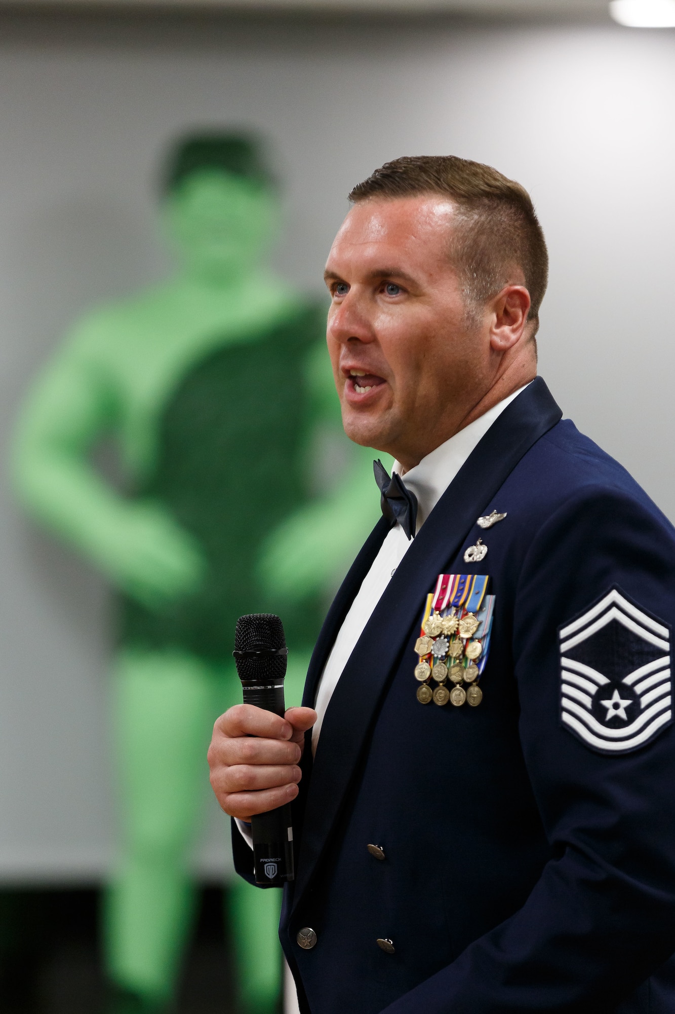 Pictured above is an Airman publicly speaking into a microphone.