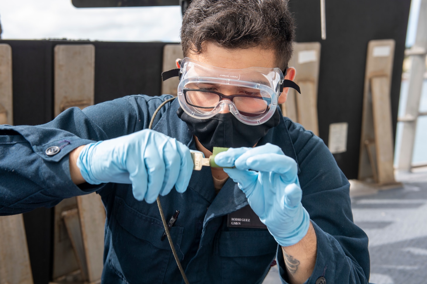 Gunner's Mate Seaman Ruben Rodriguez, from Abilene, Tex., performs routine maintenance on a lock system on the flight deck aboard Independence-variant littoral combat ship USS Jackson (LCS 6).