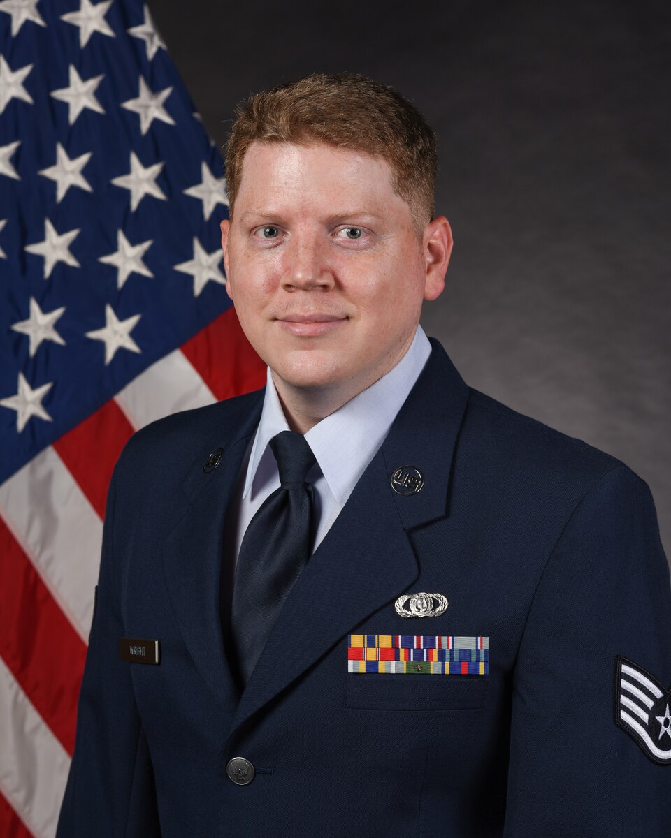 Airman posed in front of US flag