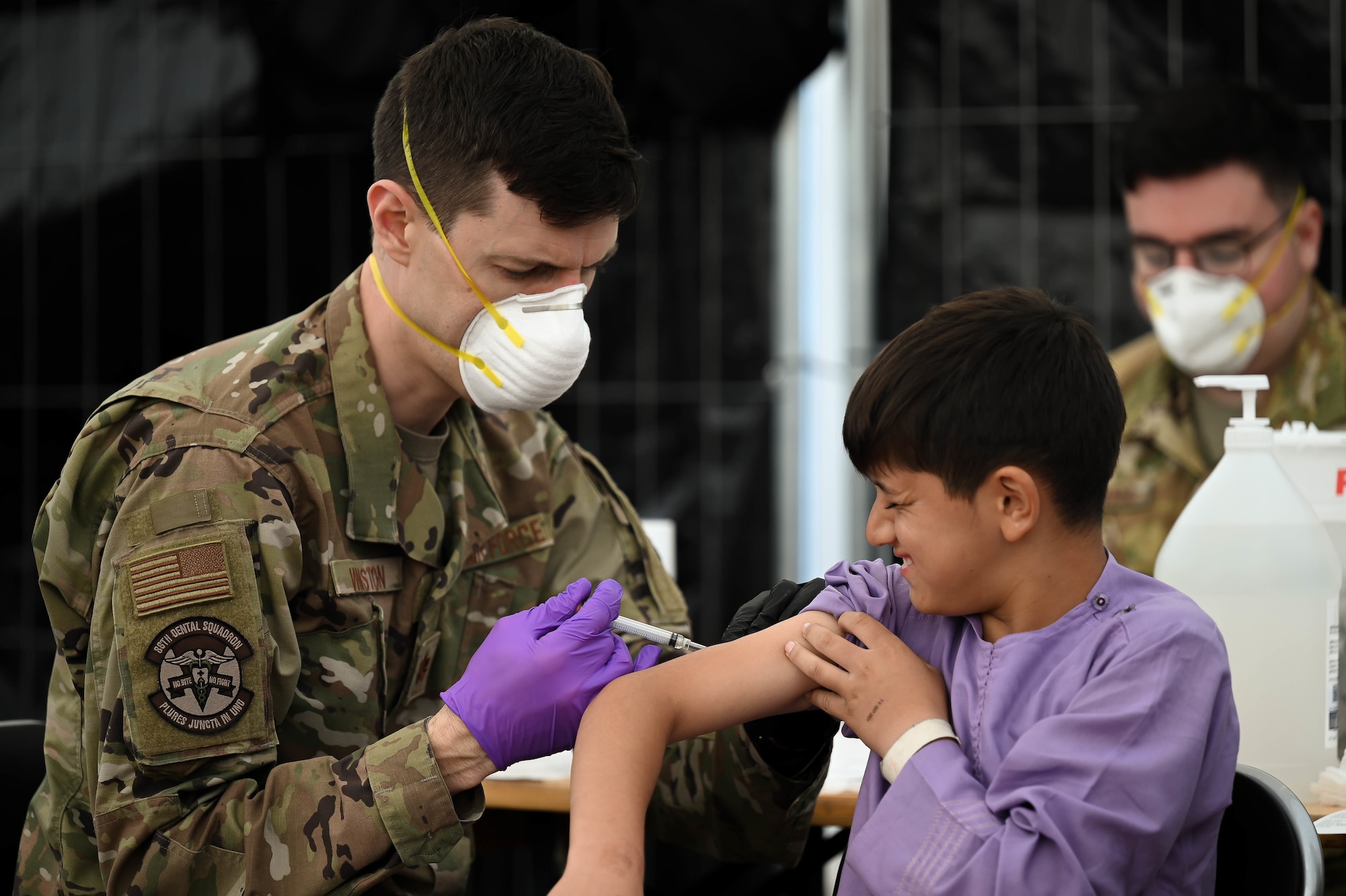 Airman administers vaccine.