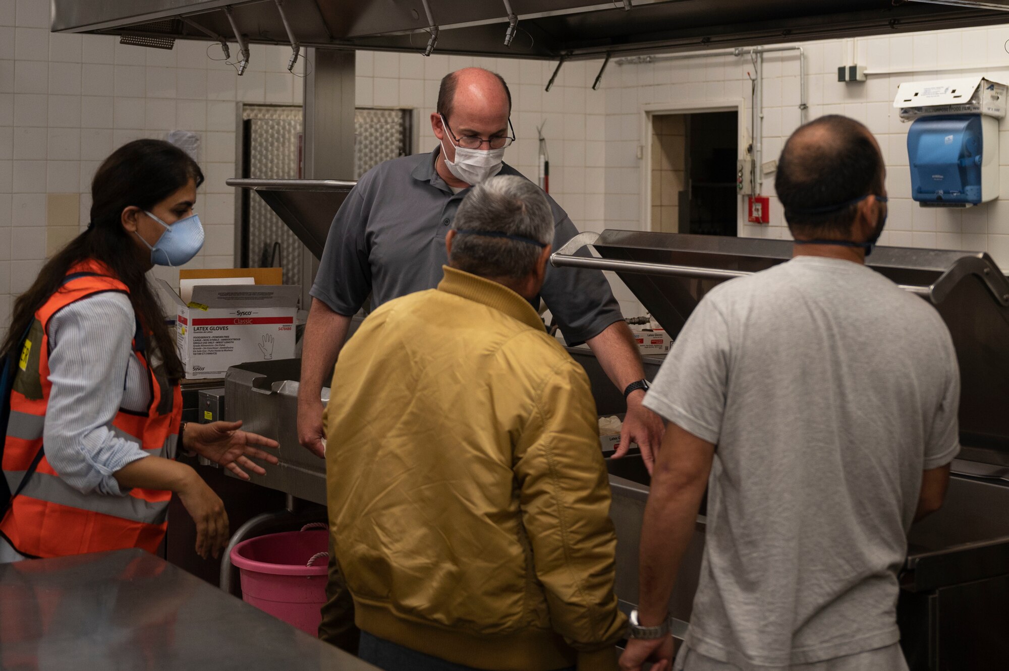 Flight Chief gives evacuees a tour of the kitchen.