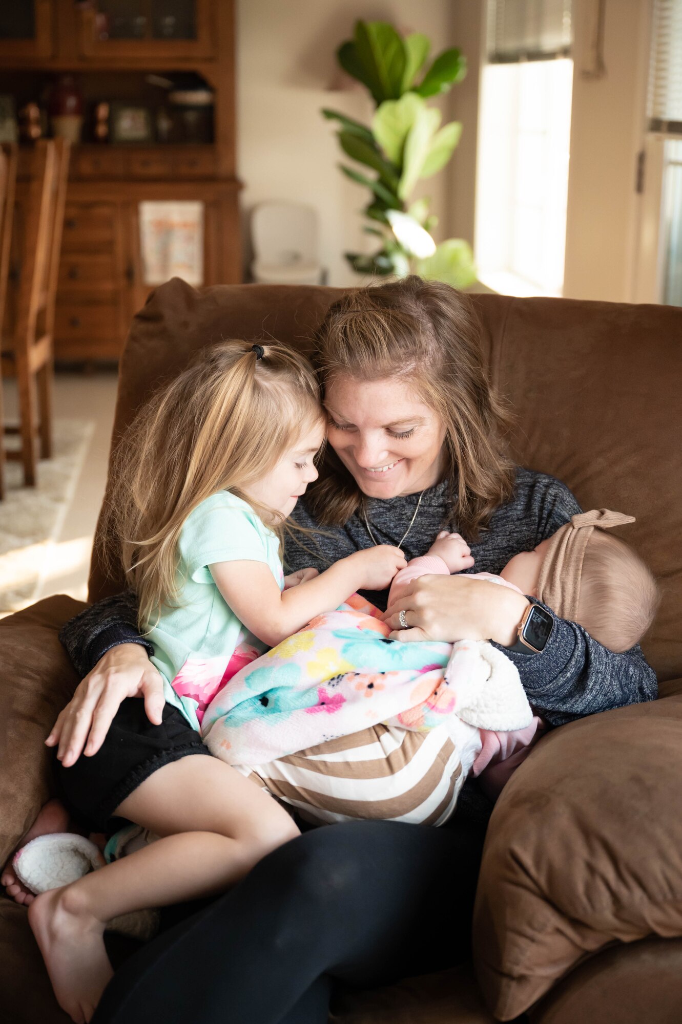 Sarah Peek, 341st Force Support Squadron Family Child Care Program provider, holds her daughter Harper Peek, left and Adalyn Shoemaker, right, daughter of Keyona and Staff Sgt. Scott Shoemaker, 341st Missile Wing defense paralegal, Sept. 8, 2021 at Malmstrom Air Force Base, Mont.