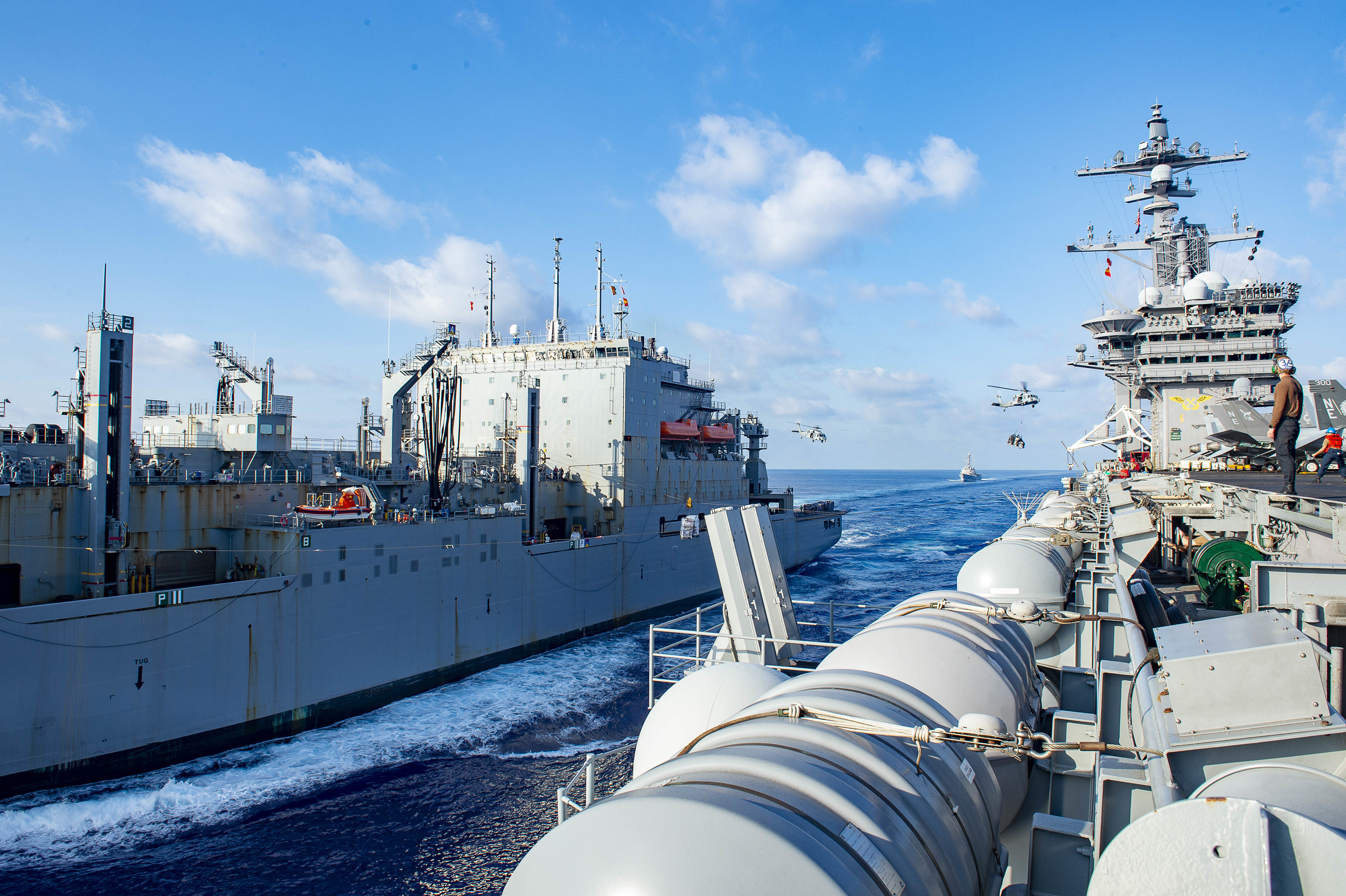 The Nimitz-class aircraft carrier USS Carl Vinson (CVN 70) conducts a vertical replenishment-at-sea with the Lewis and Clark-class dry cargo ship USNS Washington Chambers (T-AKE 11), Sept. 20, 2021.