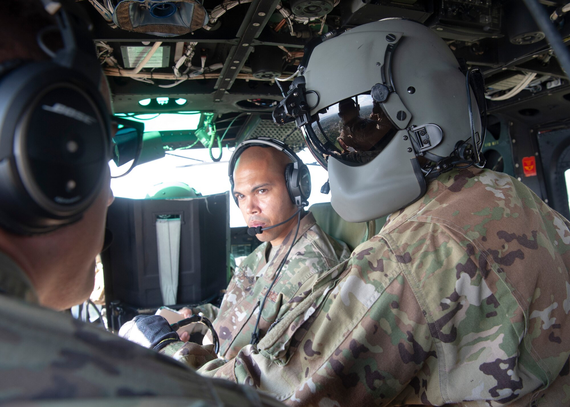 Senior Master Sgt. Christopher Ricks, Pacific Air Forces Security Forces Division current operations superintendent, and Staff Sgt. Alex Sandmann, 5th Security Forces Squadron noncommissioned officer in charge of electronic security systems, Minot Air Force Base, N.D.,  fly in a UH-1N Huey during a tour of the 1st Helicopter Squadron at Joint Base Andrews, Md., Sept. 18, 2021.  The 2021 12 Outstanding Airmen of the Year honorees were given the opportunity to tour the helicopter squadron, and received an aerial tour of the national capital region. (U.S. Air Force photo by Staff Sgt. Nicolas Z. Erwin)