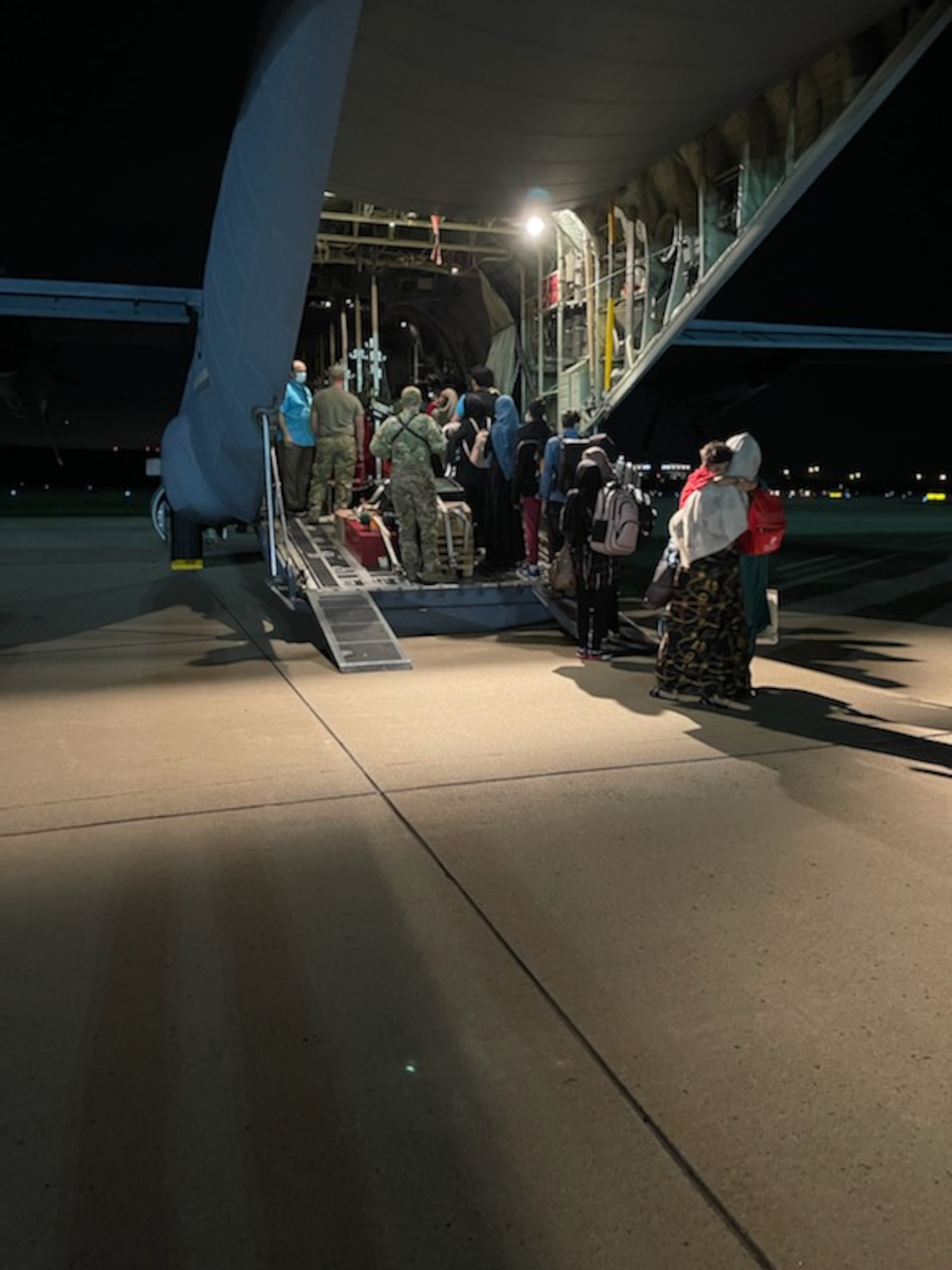 94th Airlift Wing loadmasters assigned to Dobbins Air Reserve Base, Georgia, escort Afghan evacuees onto a C-130H3 Hercules at Washington-Dulles airport prior to travel as part of Operation Allies Welcome, Sept. 4, 2021.