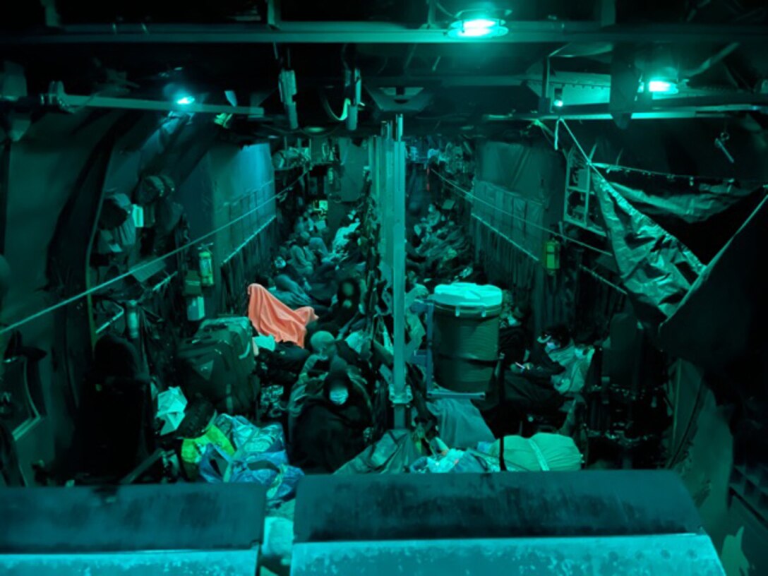 Afghan evacuees and 94th Airlift Wing loadmasters assigned to Dobbins Air Reserve Base, Georgia, prepare to fly on a C-130H3 Hercules at Washington-Dulles airport as part of Operation Allies Welcome, Sept. 4, 2021.