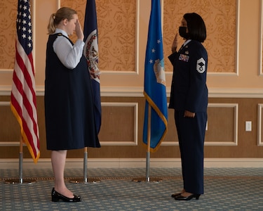 Maj. Erica Legg, 192nd Support Squadron director of operations, performs the Oath of Enlistment for Chief Master Sgt. Lawanda Jackson, 192nd SS Mobility Flight chief, during her promotion ceremony on July 10, 2021, at Joint Base Langley-Eustis, Virginia. When an Airman is promoted to chief, it is tradition to perform the Oath of Enlistment. (U.S. Air National Guard photo by Staff Sgt. Bryan Myhr)