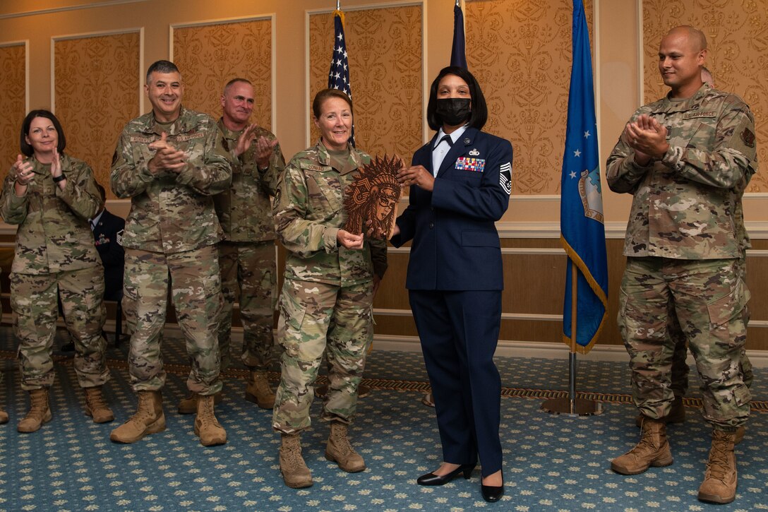 The 192nd Wing Chiefs' Council presents Chief Master Sgt. Lawanda Jackson, 192nd Support Squadron Mobility Flight chief, with a plaque during her promotion ceremony on July 10, 20221, at Joint Base Langley-Eustis, Virginia. Jackson was the first Black woman to be promoted to chief in the history of the Virginia Air National Guard. (U.S. Air National Guard photo by Tech. Sgt. Eugene Silvers)