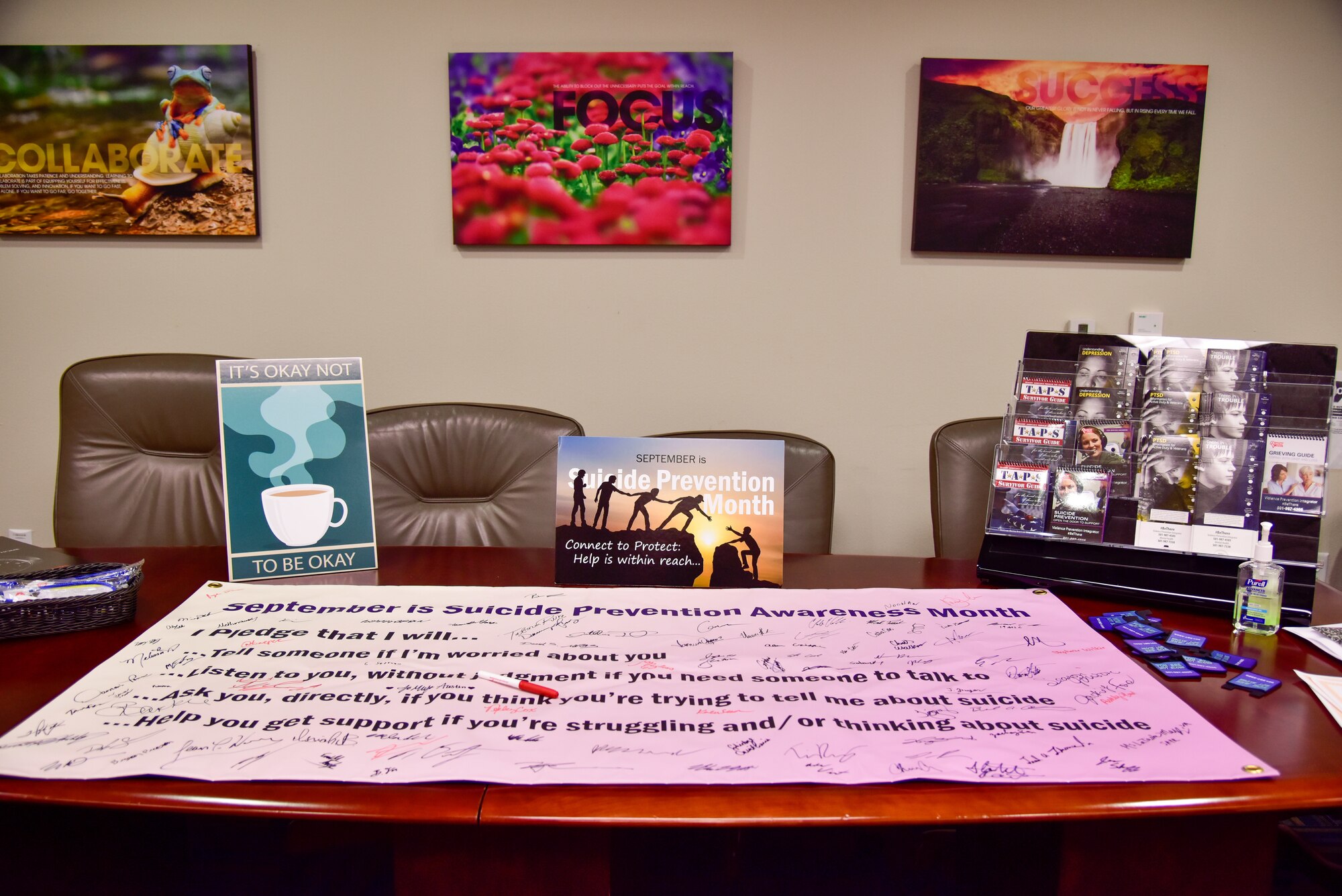 A table is filled with suicide prevention resources.