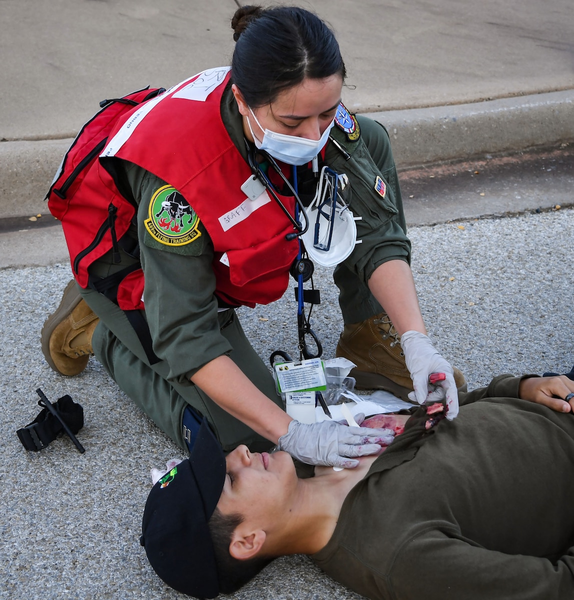 Capt. (Dr.) Alison Graff applies a dressing to a patient during a Ready Eagle exercise
