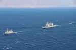 GULF OF AQABA (August 31, 2021) – Israeli Navy corvette INS Eilat (501), left, guided-missile cruiser USS Monterey (CG 61), center, and an Israeli Navy fast patrol boat transit in formation during a combined maritime security patrol in the Gulf of Aqaba, Aug. 31. Monterey is deployed to the U.S. 5th Fleet area of operations in support of naval operations to ensure maritime stability and security in the Central Region, connecting the Mediterranean and Pacific through the western Indian Ocean and three strategic choke points. (U.S. Navy photo by Naval Air Crewman 2nd Class Jesse Johnston)