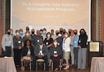 Group of men and women pose during  Insights into Industry Management Course.
