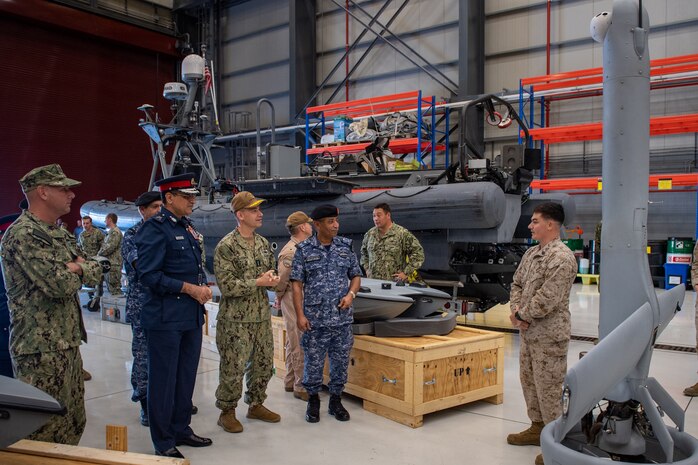 Vice Adm. Brad Cooper, commander of U.S. Naval Forces Central Command (NAVCENT), U.S. 5th Fleet and Combined Maritime Forces, center right, along with Major Gen. Ala Abdulla Seyadi, commander of the Bahrain Coast Guard, center left; and Rear Adm. Mohammed Yousif Al Asam, commander of the Royal Bahrain Naval Force, right, listen to a presentation on an unmanned aerial vehicle V-BAT system. During the visit, Bahraini leaders committed to partnering with NAVCENT to accelerate integration of new unmanned systems into regional maritime operations.