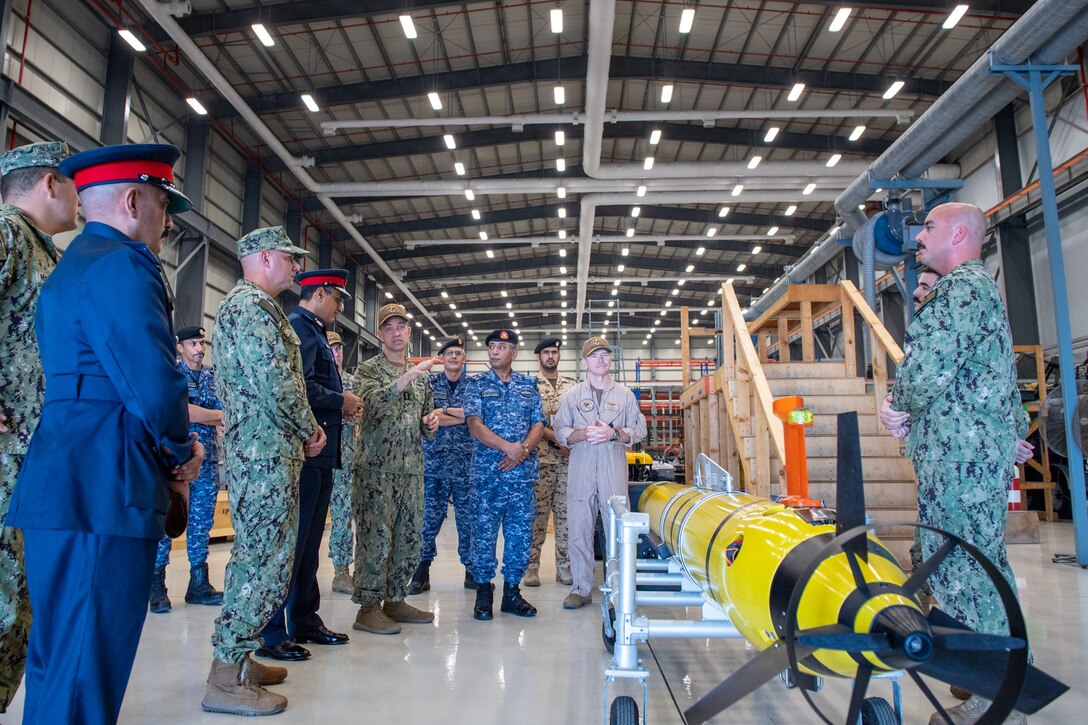 Vice Adm. Brad Cooper, commander of U.S. Naval Forces Central Command (NAVCENT), U.S. 5th Fleet and Combined Maritime Forces, center right, along with Major Gen. Ala Abdulla Seyadi, commander of the Bahrain Coast Guard, center left; and Rear Adm. Mohammed Yousif Al Asam, commander of the Royal Bahrain Naval Force, right, listen to a presentation on a Razorback unmanned underwater vehicle. During the visit, Bahraini leaders committed to partnering with NAVCENT to accelerate integration of new unmanned systems into regional maritime operations.