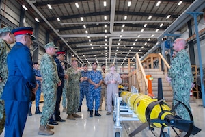 Vice Adm. Brad Cooper, commander of U.S. Naval Forces Central Command (NAVCENT), U.S. 5th Fleet and Combined Maritime Forces, center right, along with Major Gen. Ala Abdulla Seyadi, commander of the Bahrain Coast Guard, center left; and Rear Adm. Mohammed Yousif Al Asam, commander of the Royal Bahrain Naval Force, right, listen to a presentation on a Razorback unmanned underwater vehicle. During the visit, Bahraini leaders committed to partnering with NAVCENT to accelerate integration of new unmanned systems into regional maritime operations.