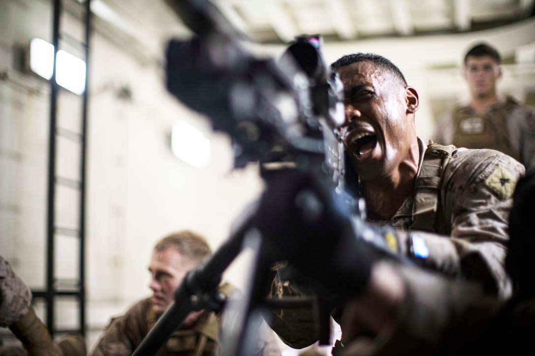 ARABIAN GULF (Sept. 21, 2021) Marine Corps Lance Cpl. River Specher, a fire team leader assigned to Alpha Company, Battalion Landing Team 1/1, 11th Marine Expeditionary Unit (MEU), yells commands during machine gun employment drills aboard the amphibious transport dock USS Portland (LPD 27). Portland and the 11th Marine Expeditionary Unit are deployed to the U.S. 5th Fleet area of operations in support of naval operations to ensure maritime stability and security in the Central Region, connecting the Mediterranean and Pacific through the Western Indian Ocean and three strategic choke points. (U.S. Marine Corps photo by Sgt. Alexis Flores/Released)