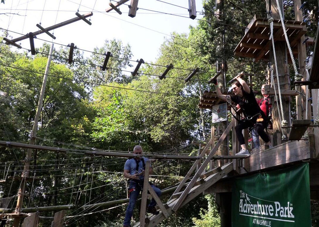 U.S. Army Corps of Engineers Nashville District Assistant District Counsel Johanna Anderson puts her best foot forward as she advances through the ropes course at The Adventure Park at Nashville.